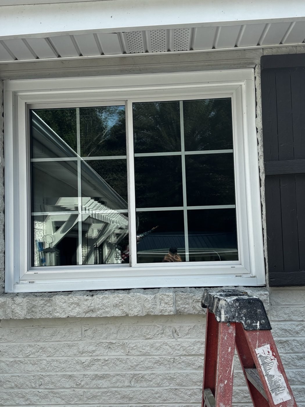 Before — grid-pane slider window and stone sill